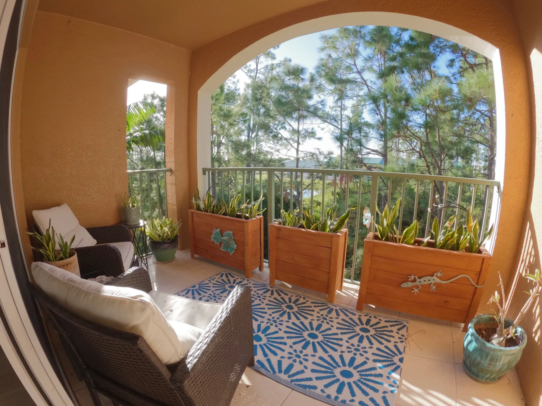 Stunning sunrise over the wooded view from the third-floor balcony at Royal Palm Retreat in Naples FL