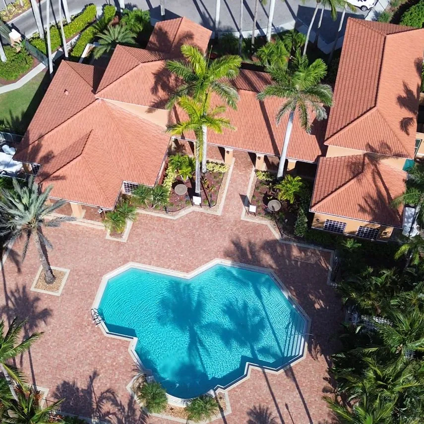 Heated resort pool with lounge chairs in the active community at Royal Palm Retreat, Naples FL